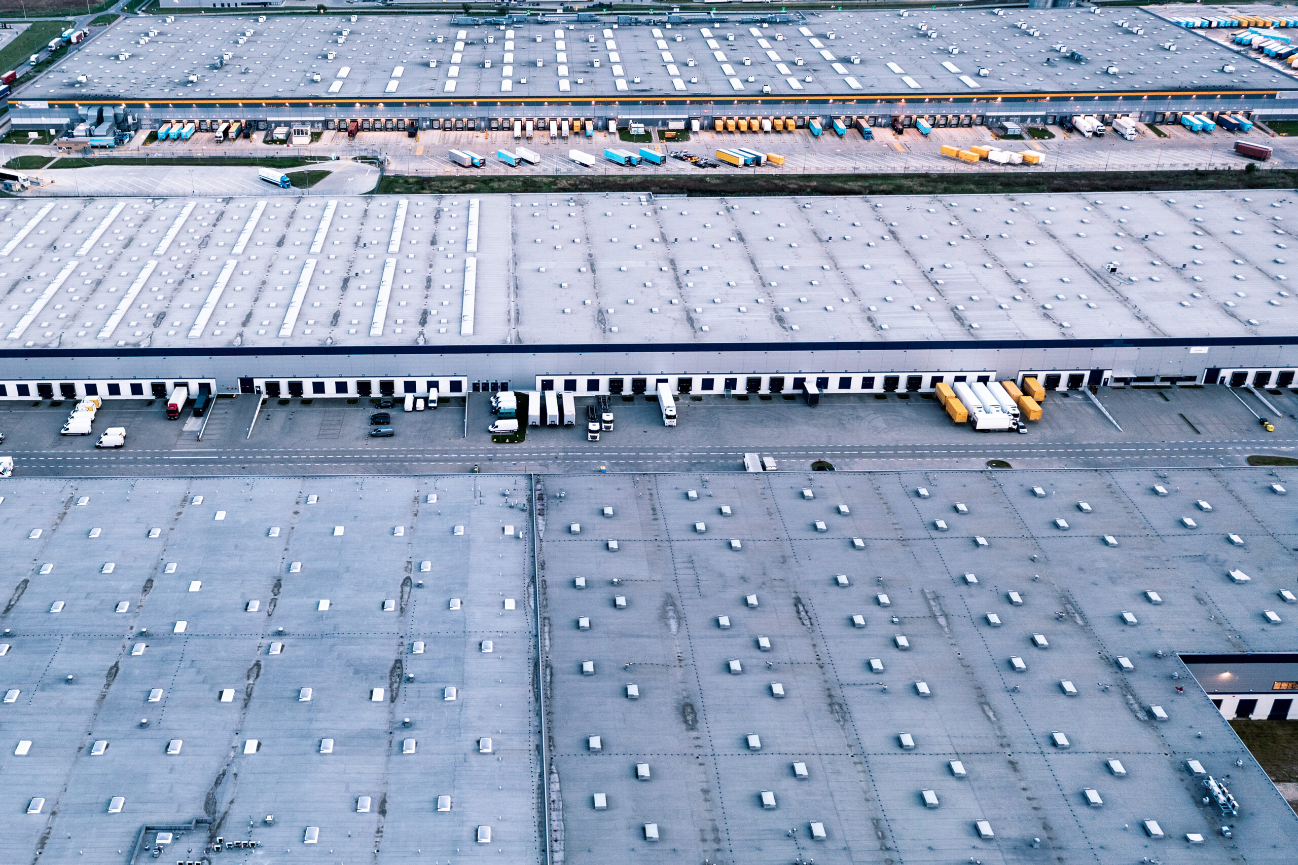 aerial view warehouse trucks with trailers stand parking lot near logistics warehouse warehouses online store industrial zone view from great height scaled